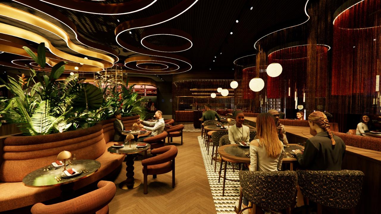 The Aura dining room — curved banquette seating in terracotta tones, a sculptural lit ceiling, and tropical planting framing the space.